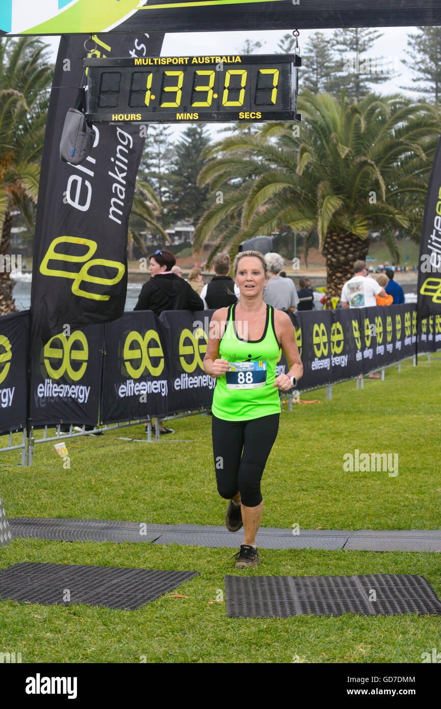 A pretty woman finishing the Kiama Coastal Classic Run Race, Kiama, Illawarra Coast, New South Wales, Australia Stock Photo