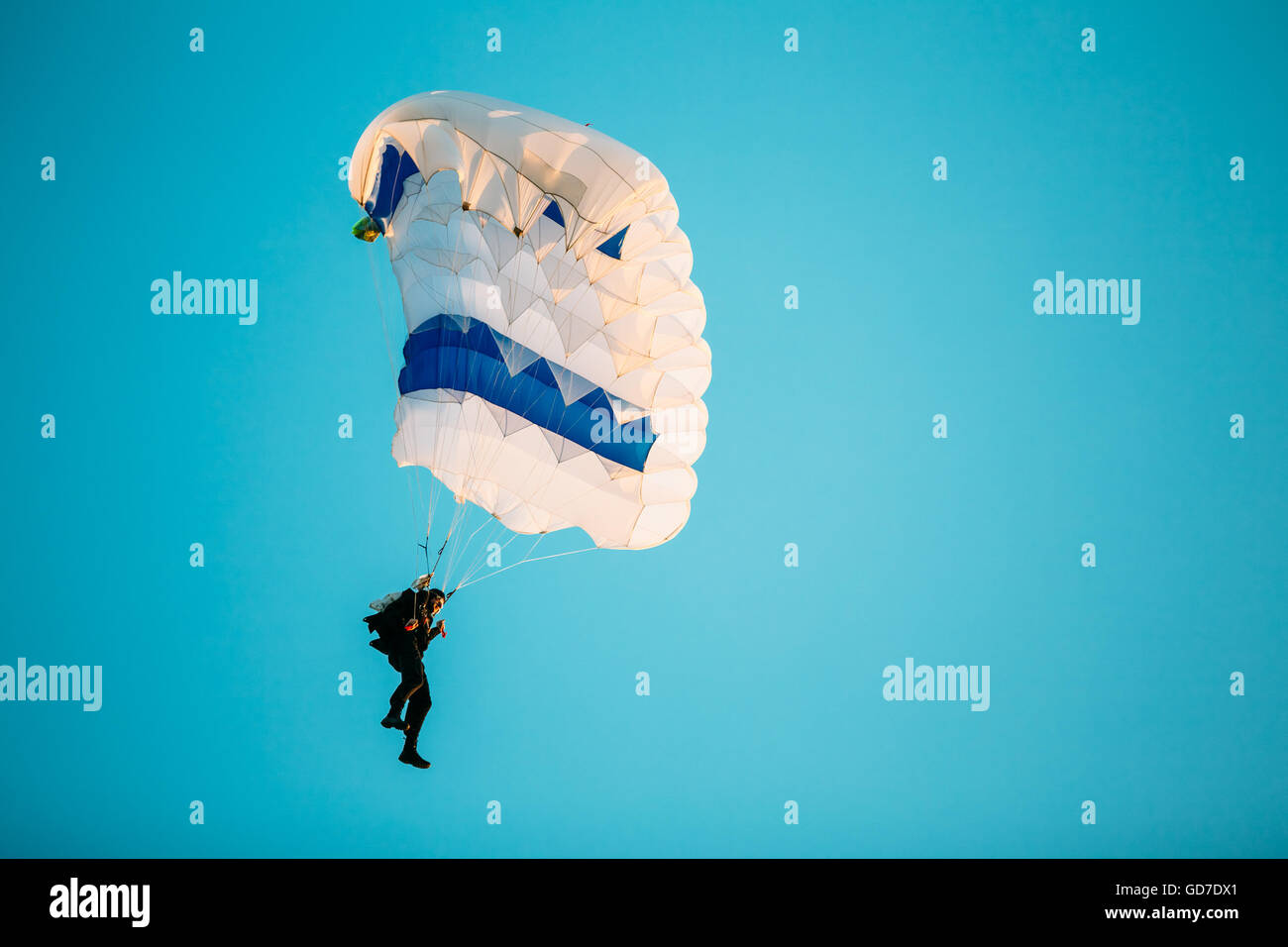 Skydiver On Colorful Parachute In Sunny Clear Sky. Active Hobbies Stock Photo