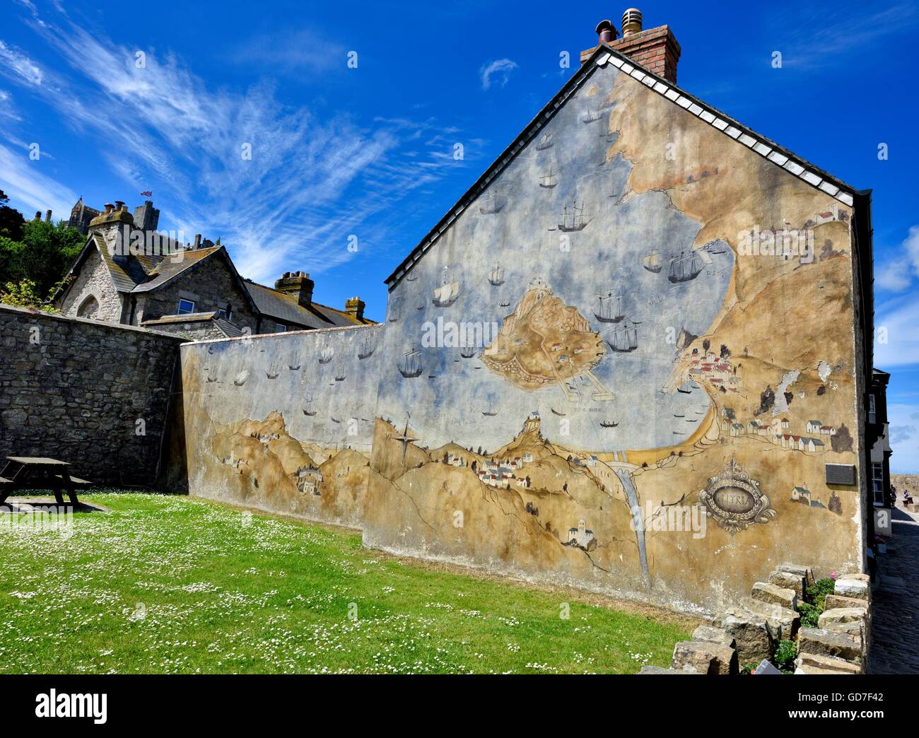 A mural of the story of st.michael's mount on the gable end of a building Cornwall England UK Stock Photo