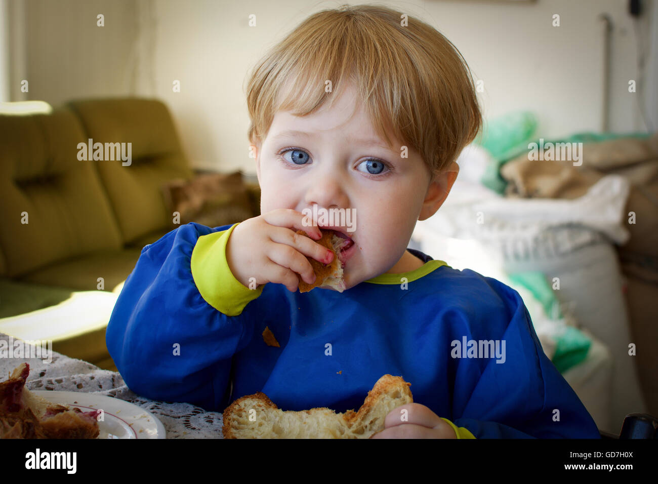 toddler boy eating bread with jam Stock Photo Alamy