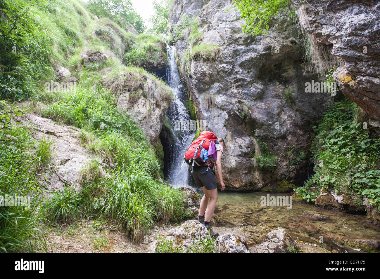 Hiking, in, Picos de Europe,Europa National Park,Spain.Waterfall near Bulnes village.Macizo Central Region,Asturias,Northern Spain Stock Photo
