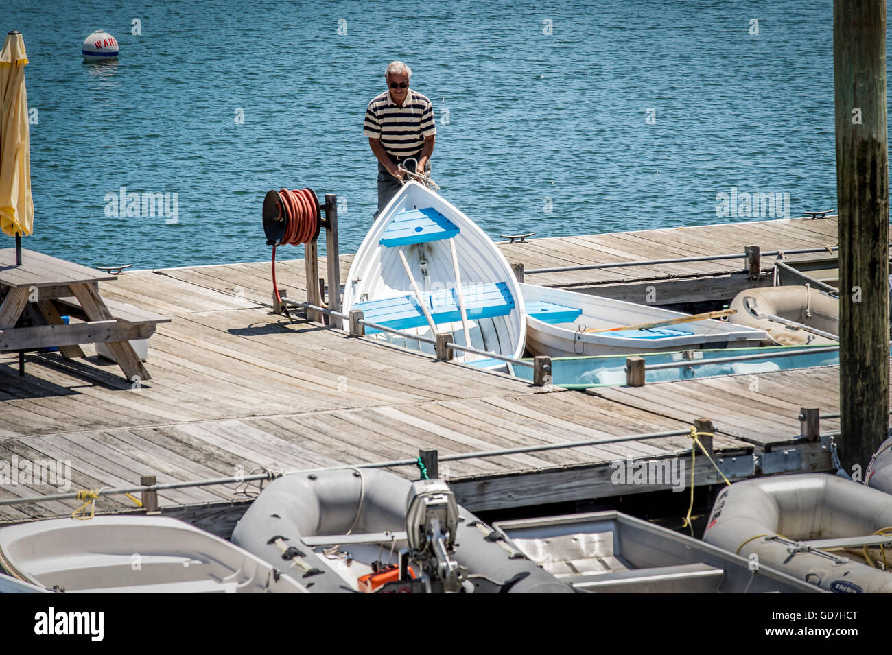 In the summer months when the harbor is full of all kinds of boats, getting out to them can be a problem, and no fun, just work. Stock Photo