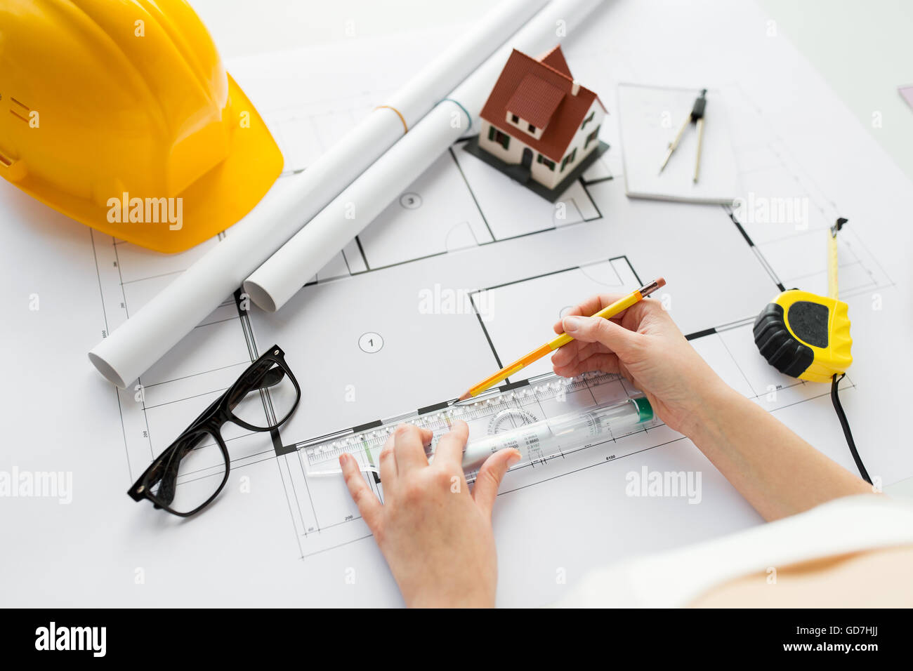 close up of hands with ruler measuring blueprint Stock Photo - Alamy