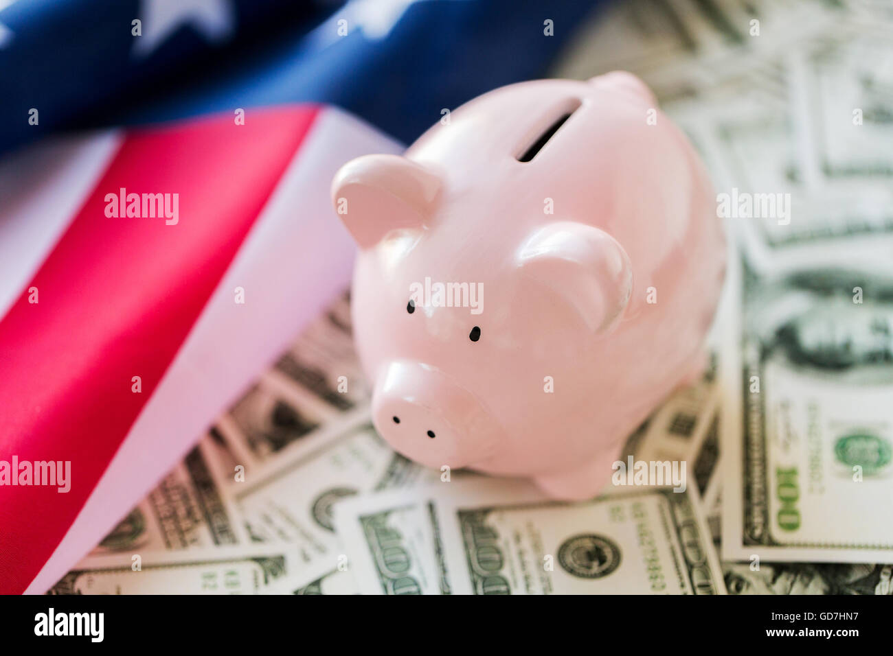 close up of american flag, piggy bank and money Stock Photo