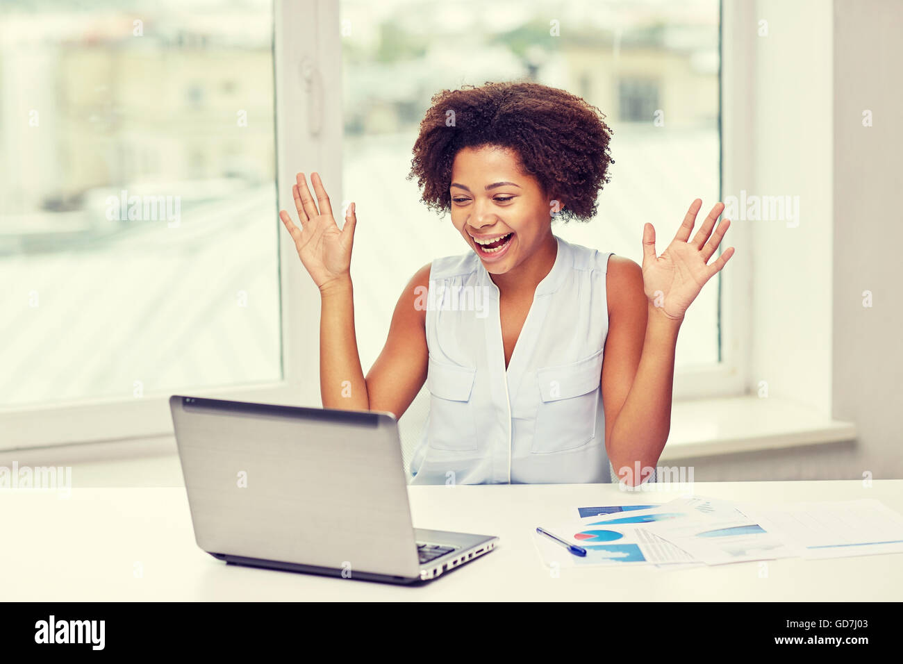 happy african woman with laptop at office Stock Photo - Alamy