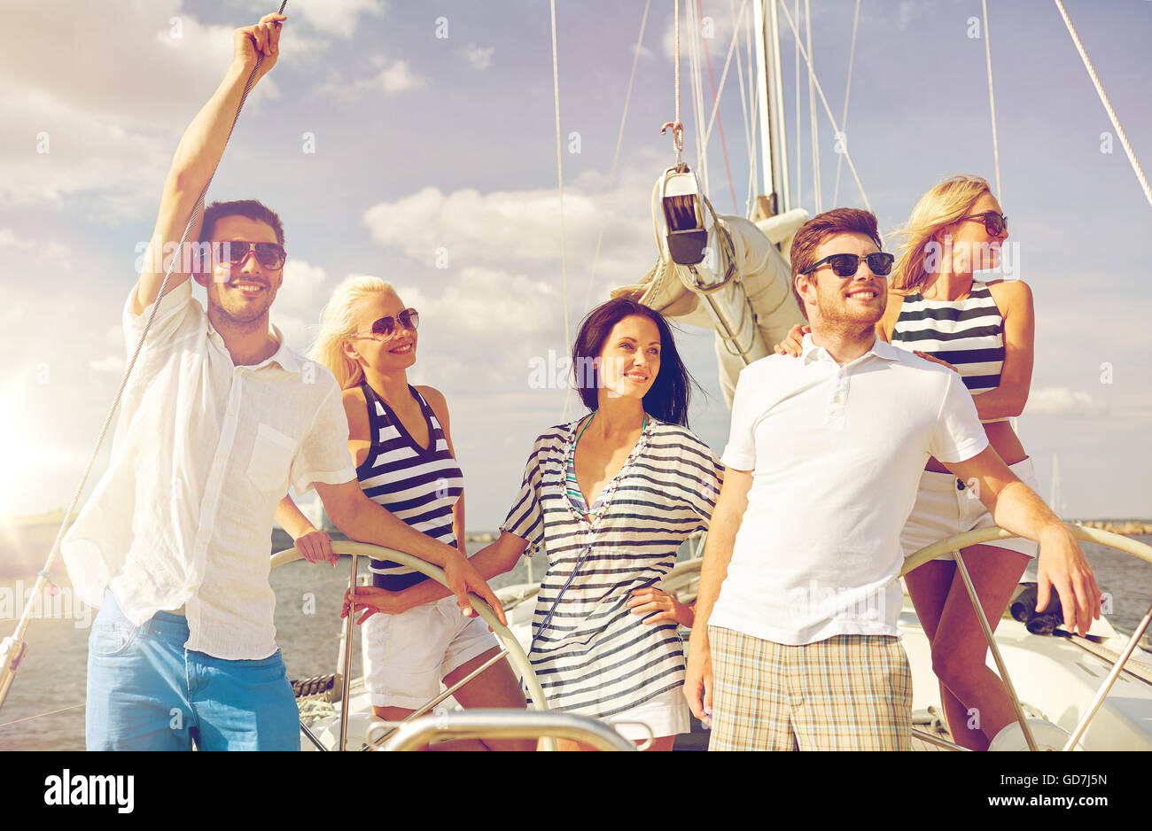 smiling friends sailing on yacht Stock Photo