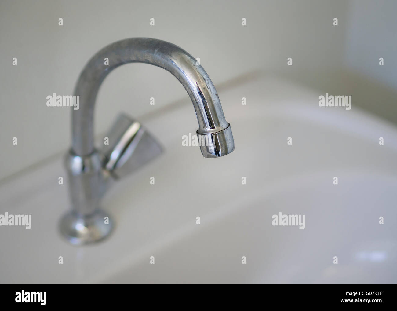 White porcelain lavatory with a simple, chromed faucet Stock Photo
