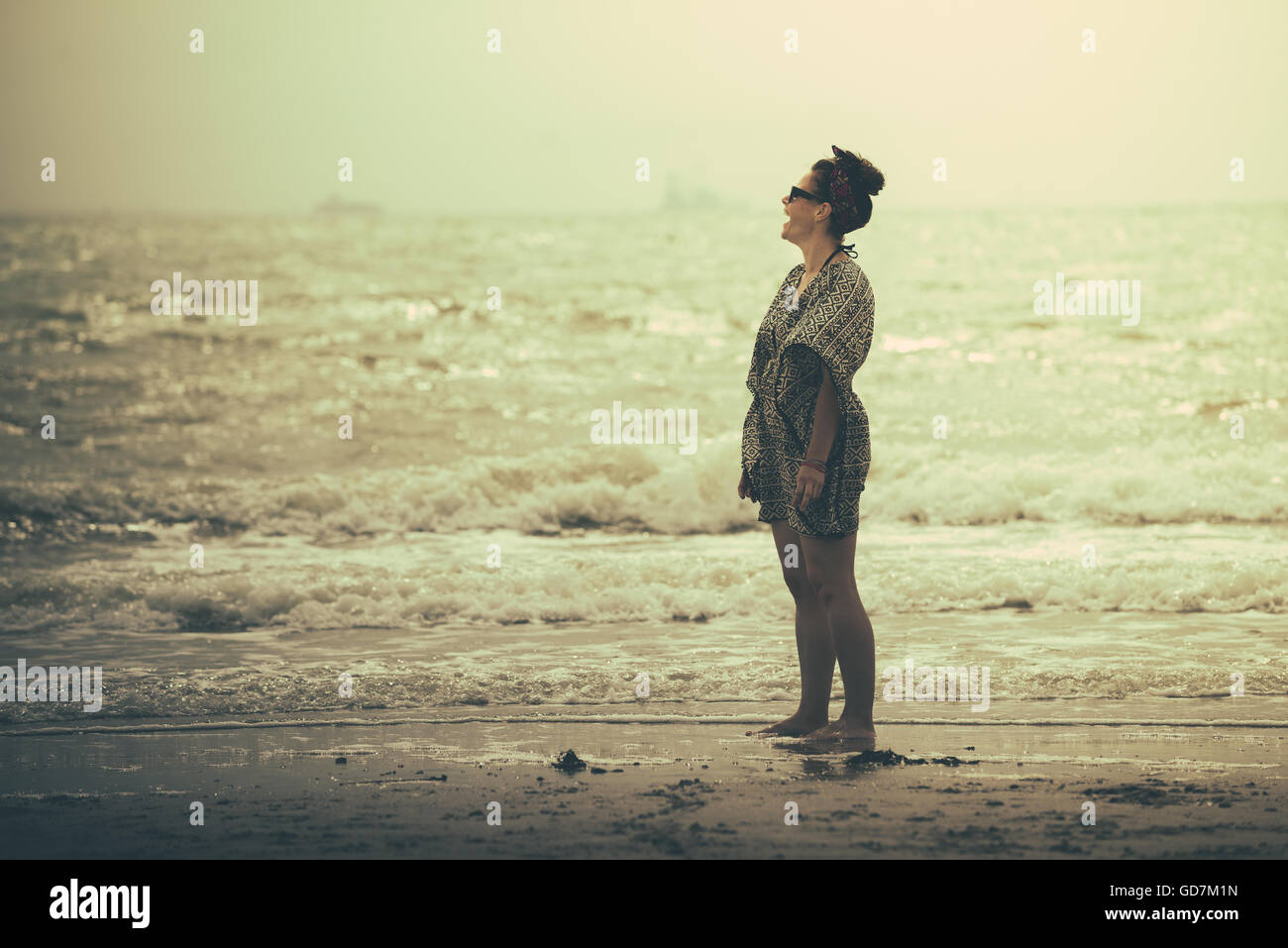 Woman sunset beach carefree hi-res stock photography and images - Alamy