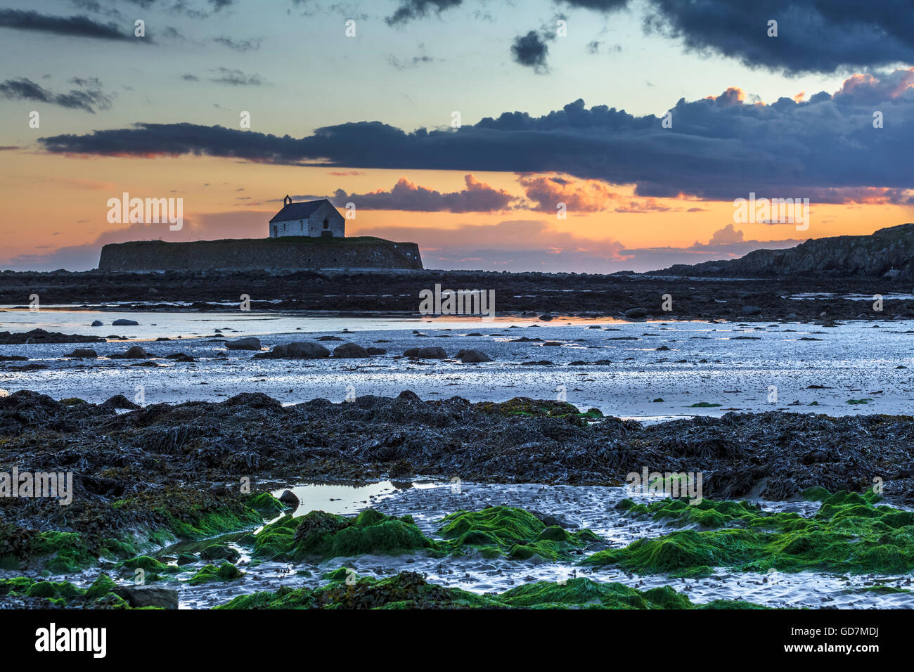 St. Cwyfan's Church at sunset on Anglesey Wales Uk Stock Photo