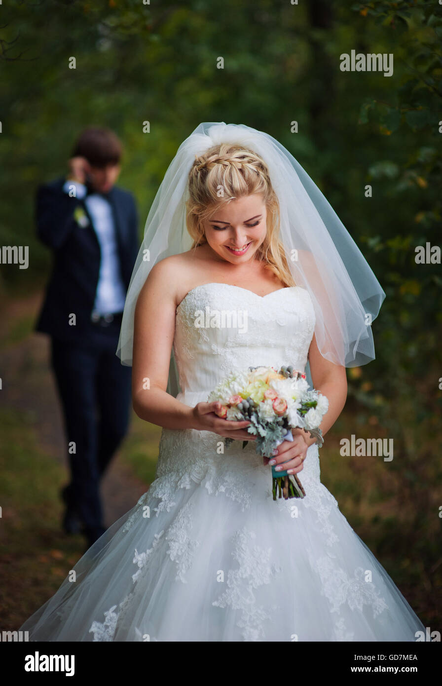 Bride and groom in the summer forest Stock Photo - Alamy