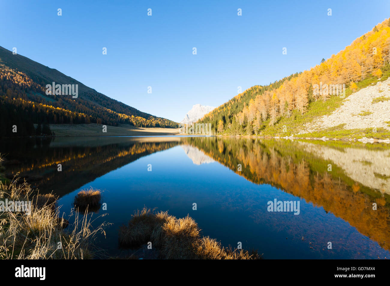 Mountain panorama from Italian Alps. Reflections on water from 'Calaita' lake. Beautiful dolomites Stock Photo