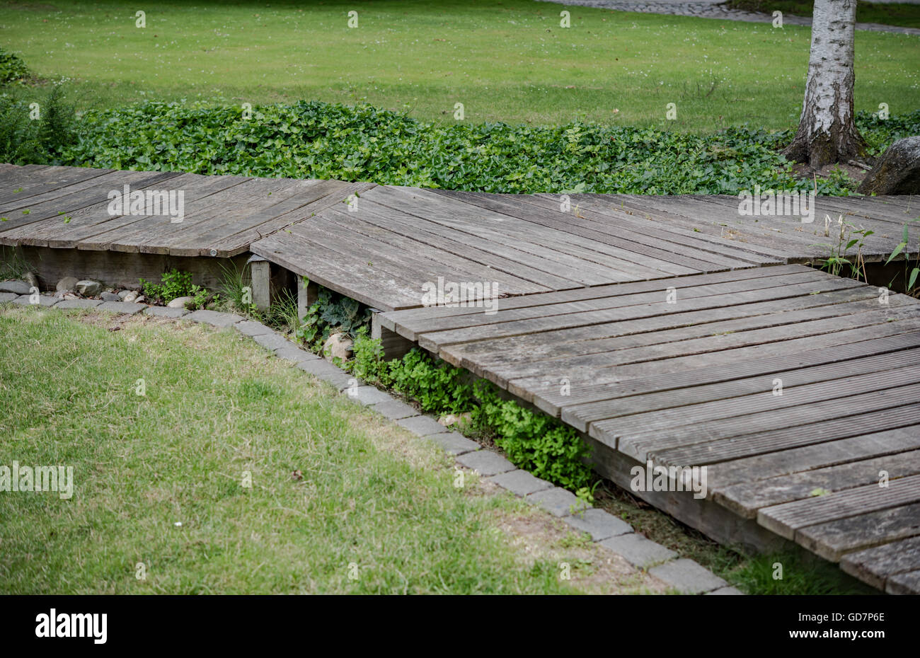 Wooden bridge in a forest along the trekking path Stock Photo - Alamy