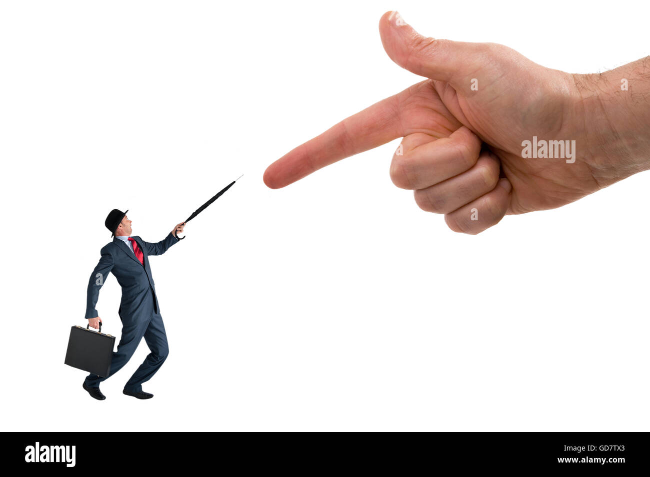 business accusation concept - giant finger pointing aggressively at a defensive businessman Stock Photo
