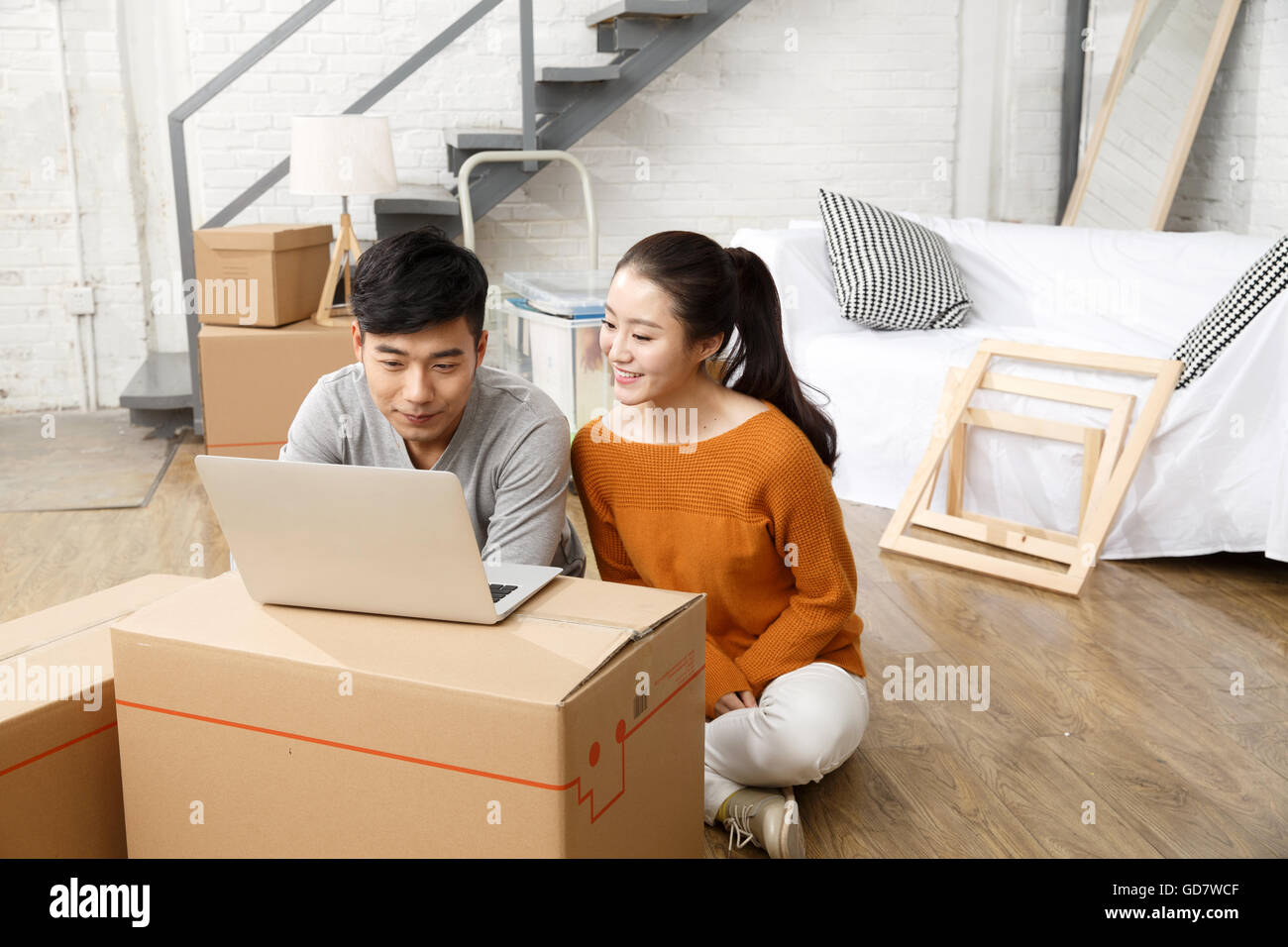 East asian couple sitting on the floor hi-res stock photography and ...