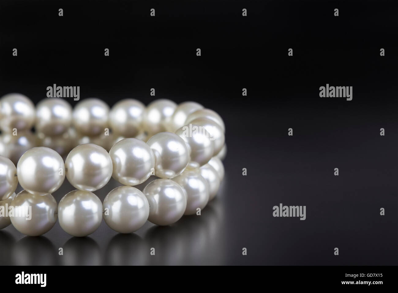White pearls necklace on black background Stock Photo Alamy