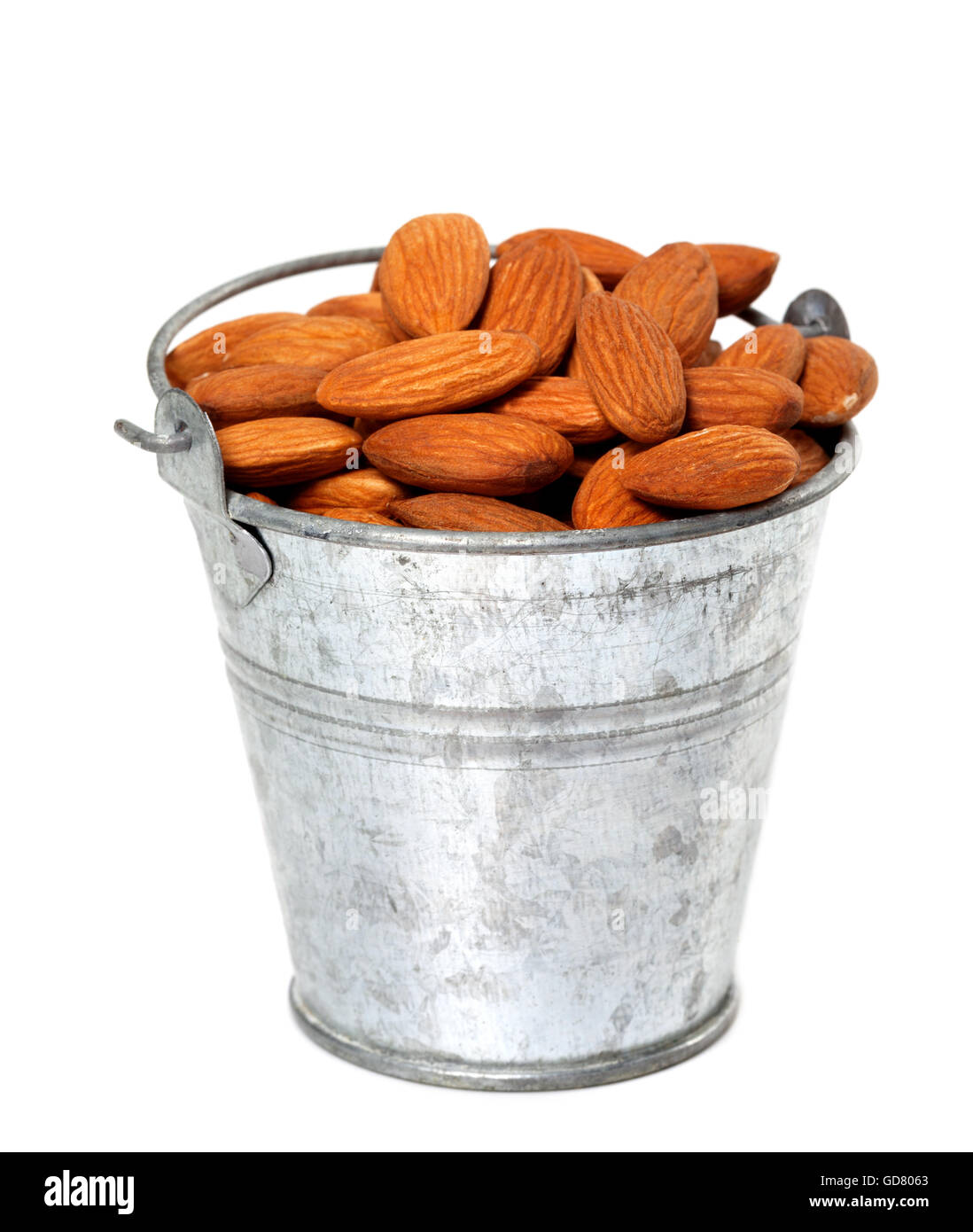 Old tin bucket with almonds. Isolated on white background Stock Photo Alamy