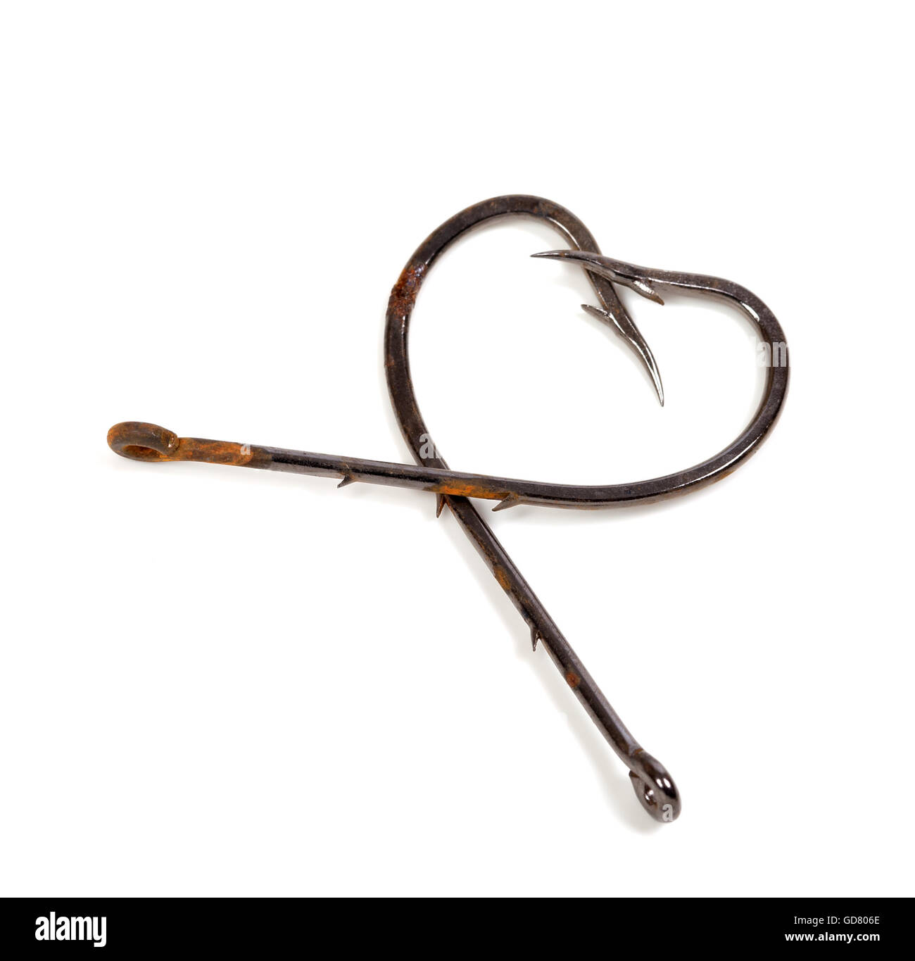 Old fish hooks in form of heart isolated on white background Stock