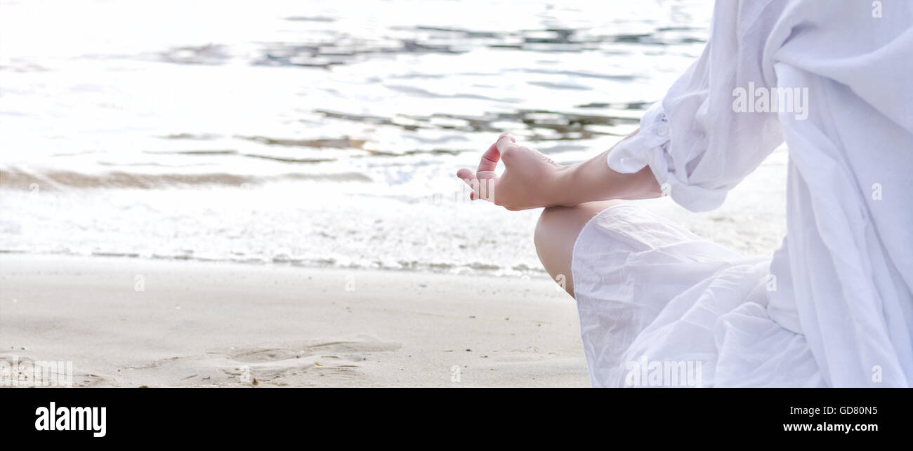 Woman meditating at the sea Stock Photo - Alamy
