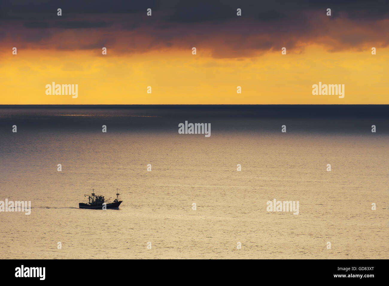 fishing ship at the sunset Stock Photo