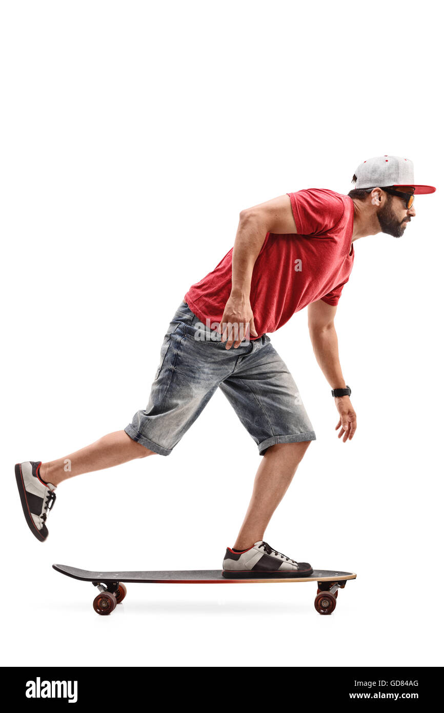 Full length profile shot of a male skater riding a longboard isolated