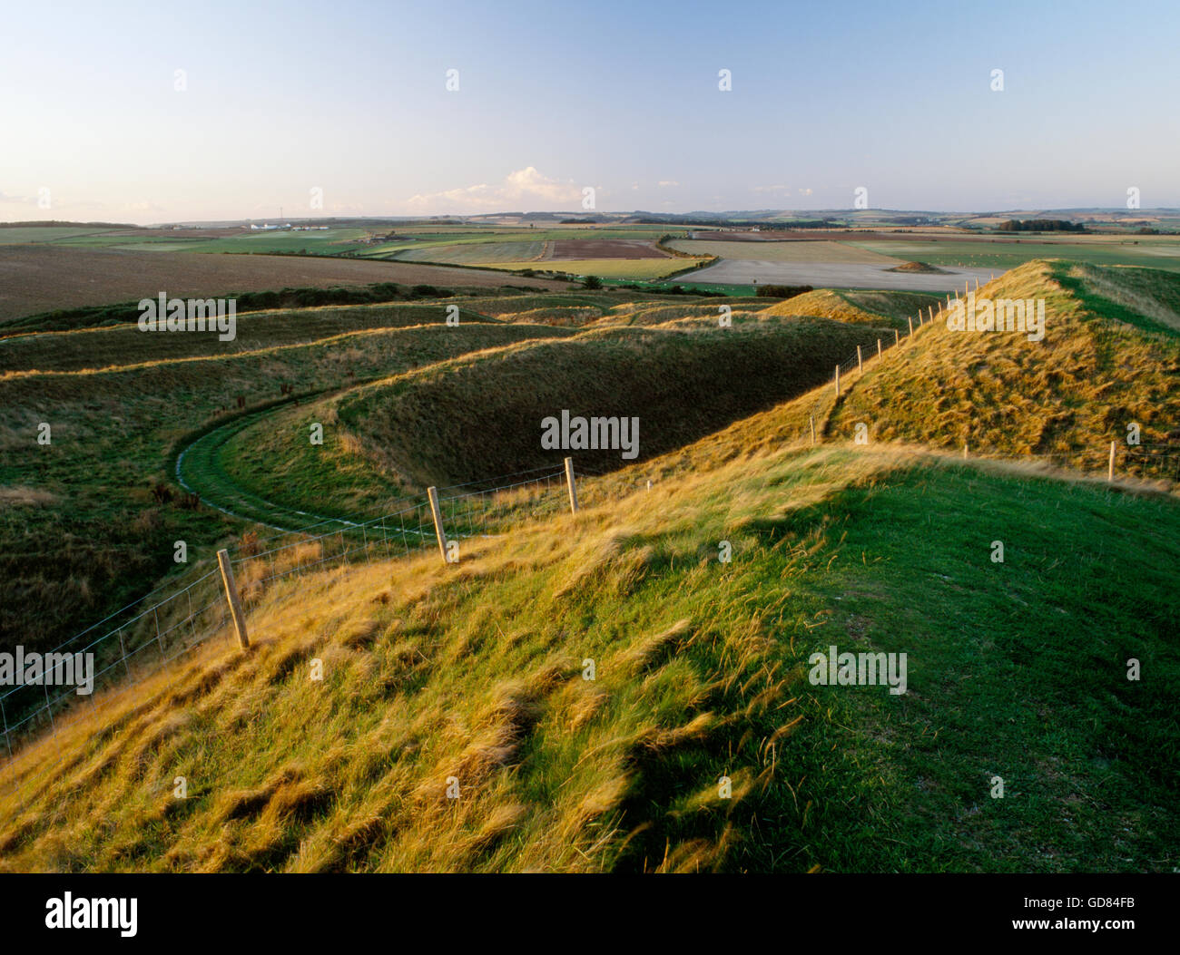 The multiple ditch and bank defences at the western entrance to Maiden Castle near Dorchester Stock Photo
