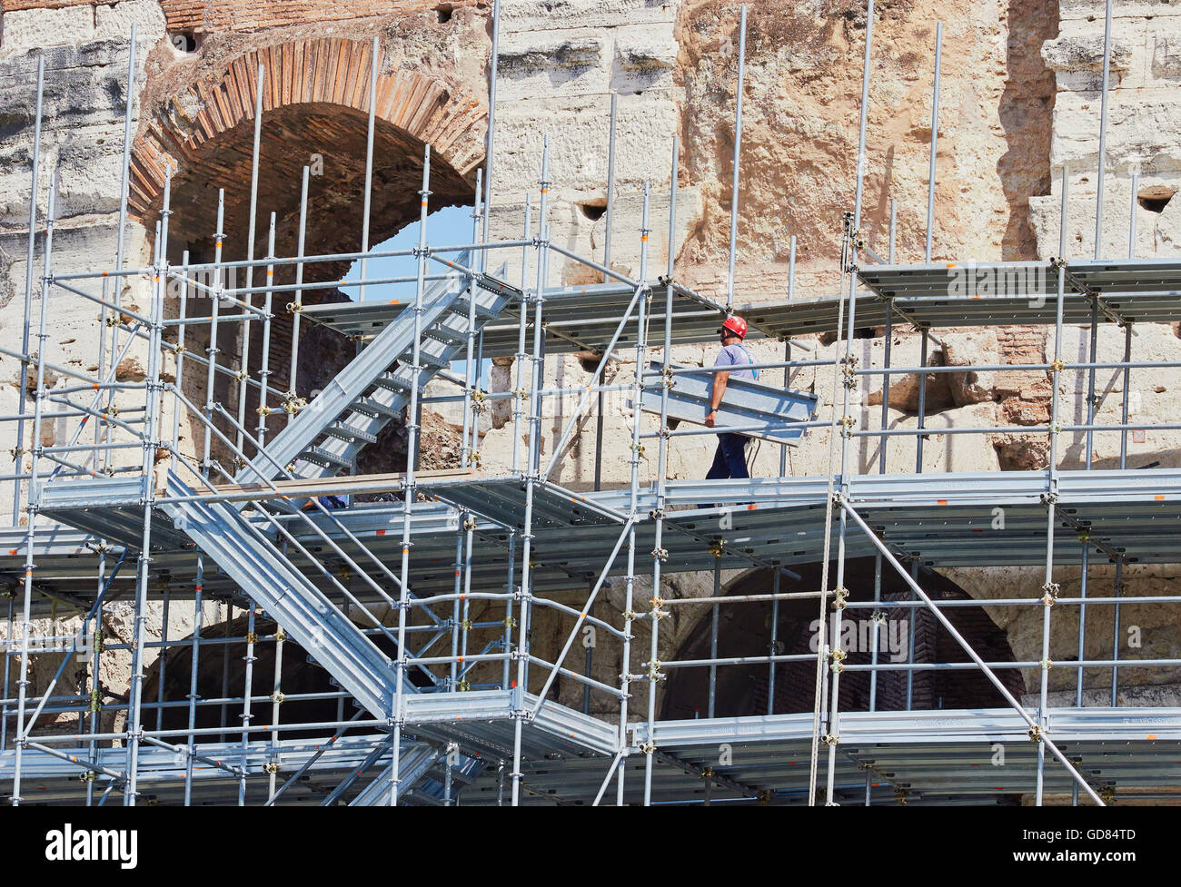 Workman on scaffolding restoring the exterior of the Colosseum Rome Lazio Italy Europe Stock Photo