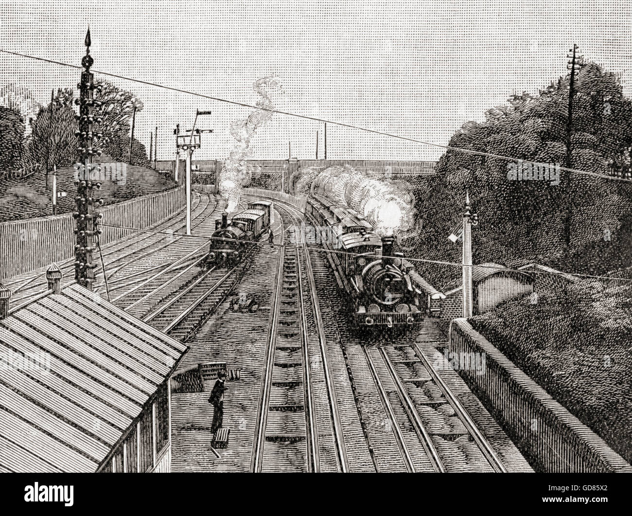 The Flying Dutchman, right, passing Acton station, London, England on the Great Western Railway at sixty miles an hour in the 19th century.  The Great Western Railway operated on a dual gauge system using a broad gauge of 7 ft (until 1892) and a standard gauge of 4 ft 8 1⁄2 in. Stock Photo