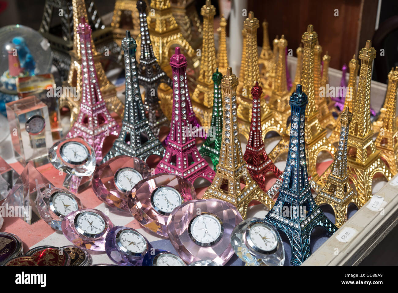 A selection of vibrant jeweled miniature Eiffel Tower souvenirs for sale in Boulogne-sur-Mer, France. Stock Photo