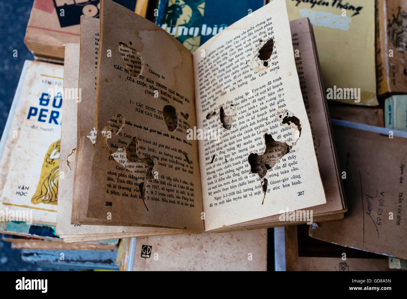 A book at the flea market eaten by bookworms in Vietnam Stock Photo