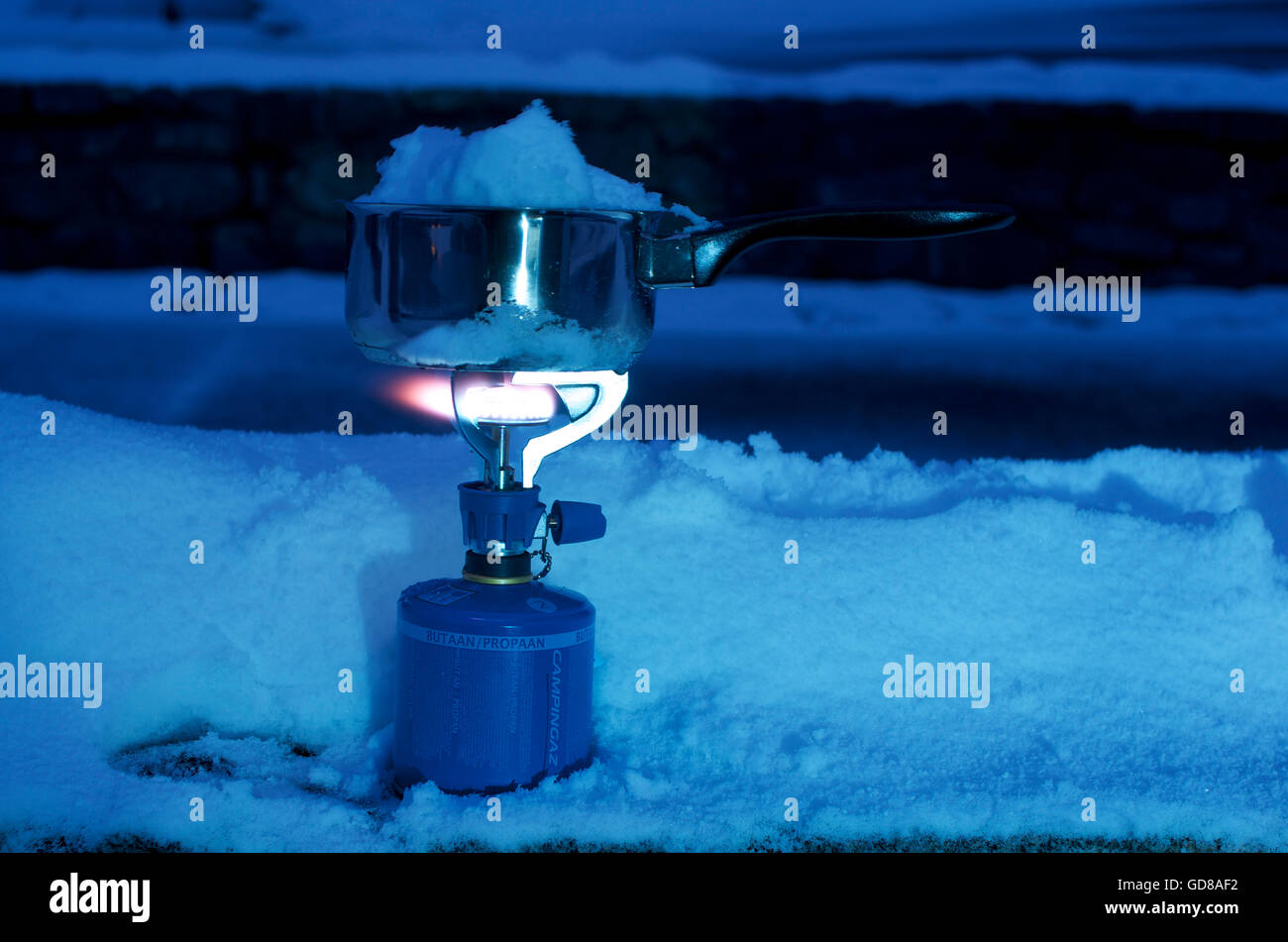 Melting snow on a gas camping stove Stock Photo Alamy