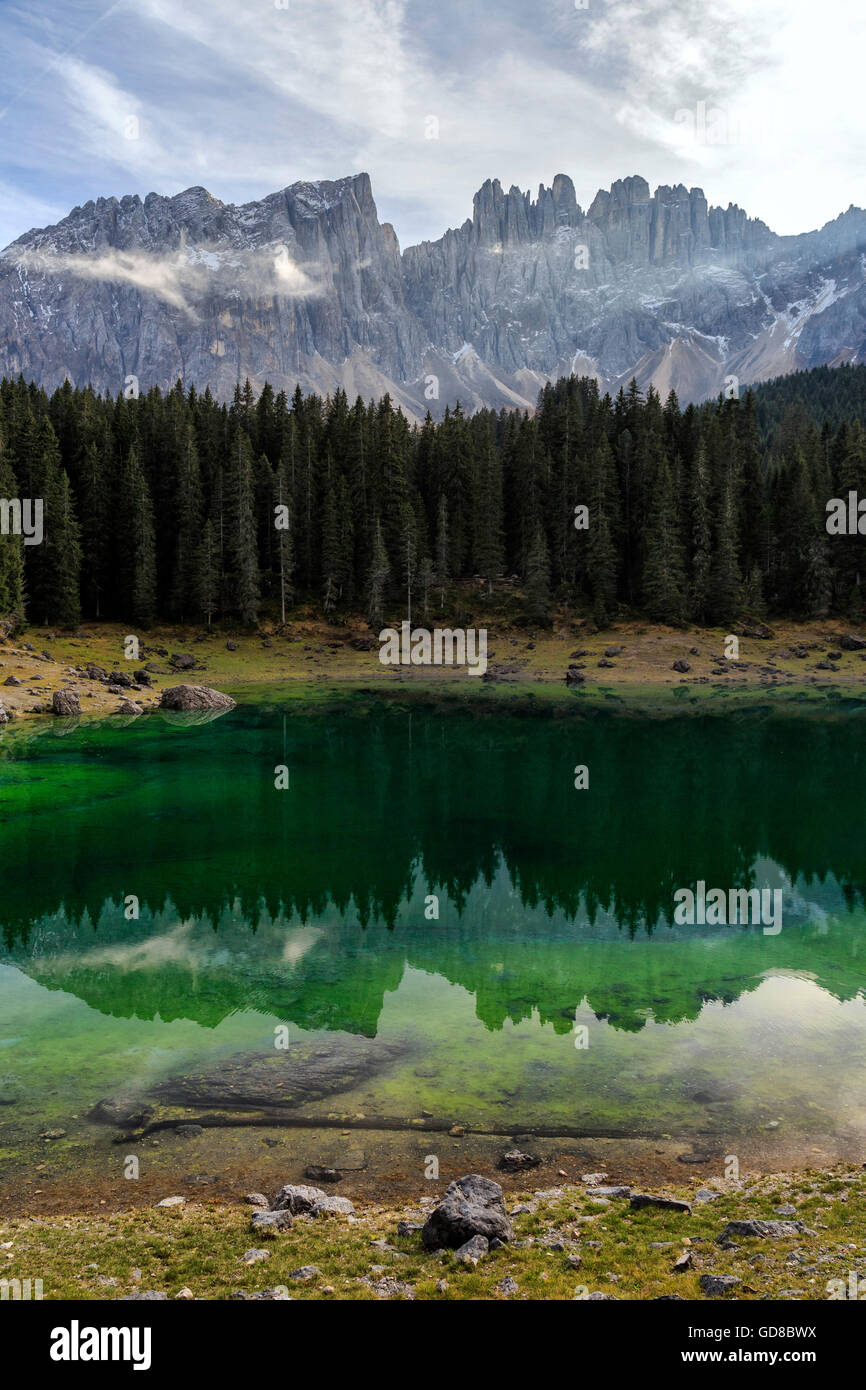Latemar group reflected in the green waters of Lake Carezza Dolomites Ega valley South Tyrol Trentino Alto Adige Italy Stock Photo