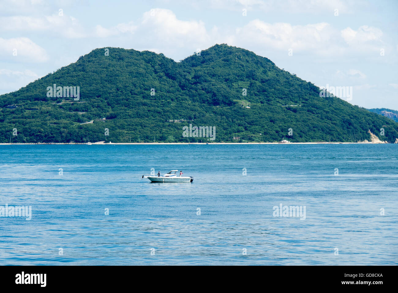 Two fishers fishing from a small boat in the Seto Inland Sea, Japan. Stock Photo