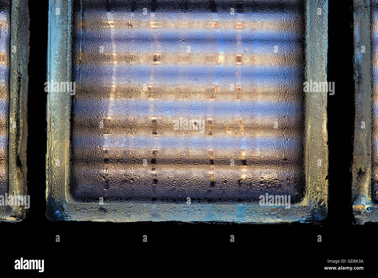 Condensation on a glass block window creates an interesting pattern Stock Photo