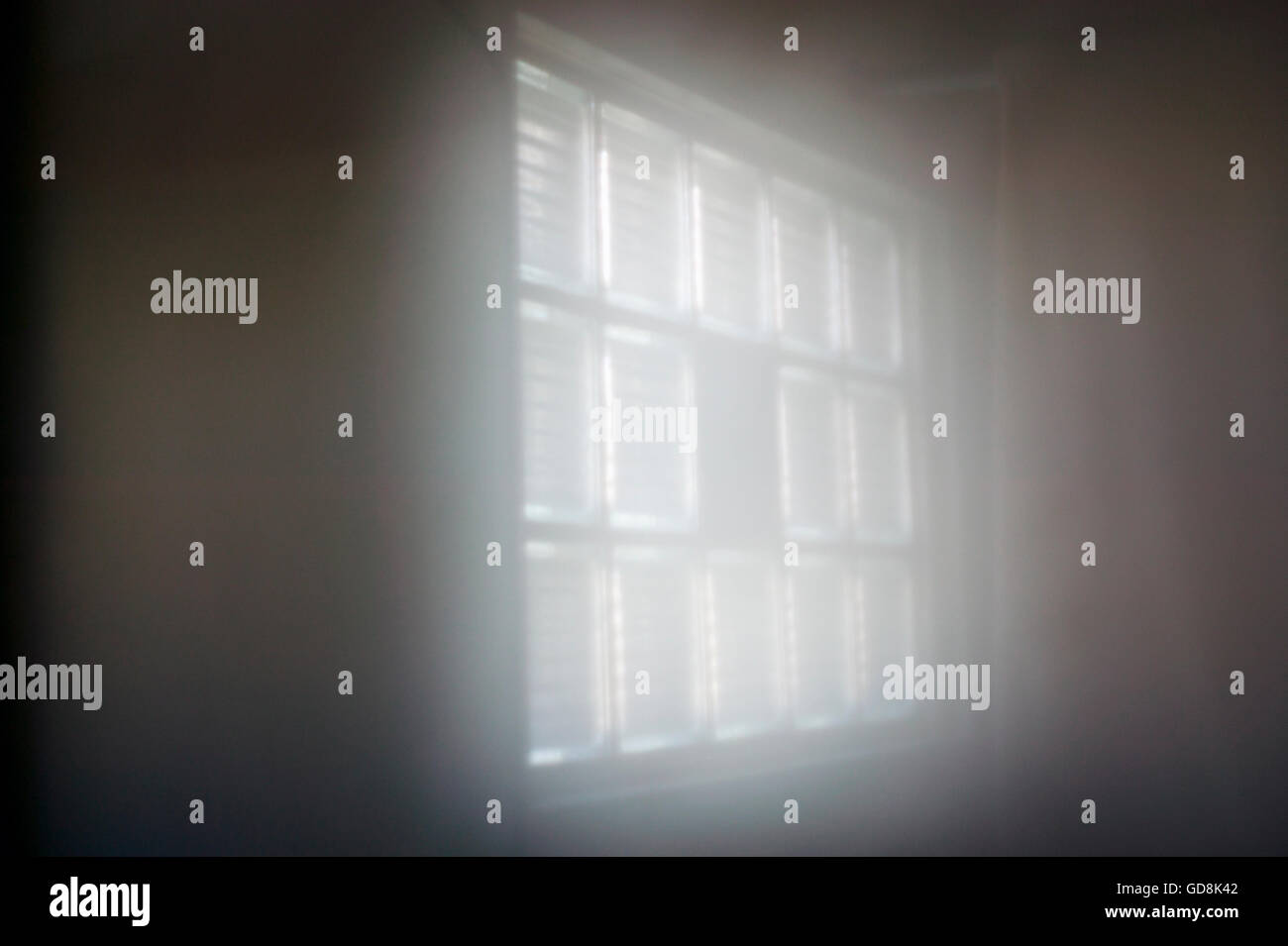 Sunlight through glass block window creates foggy effect Stock Photo
