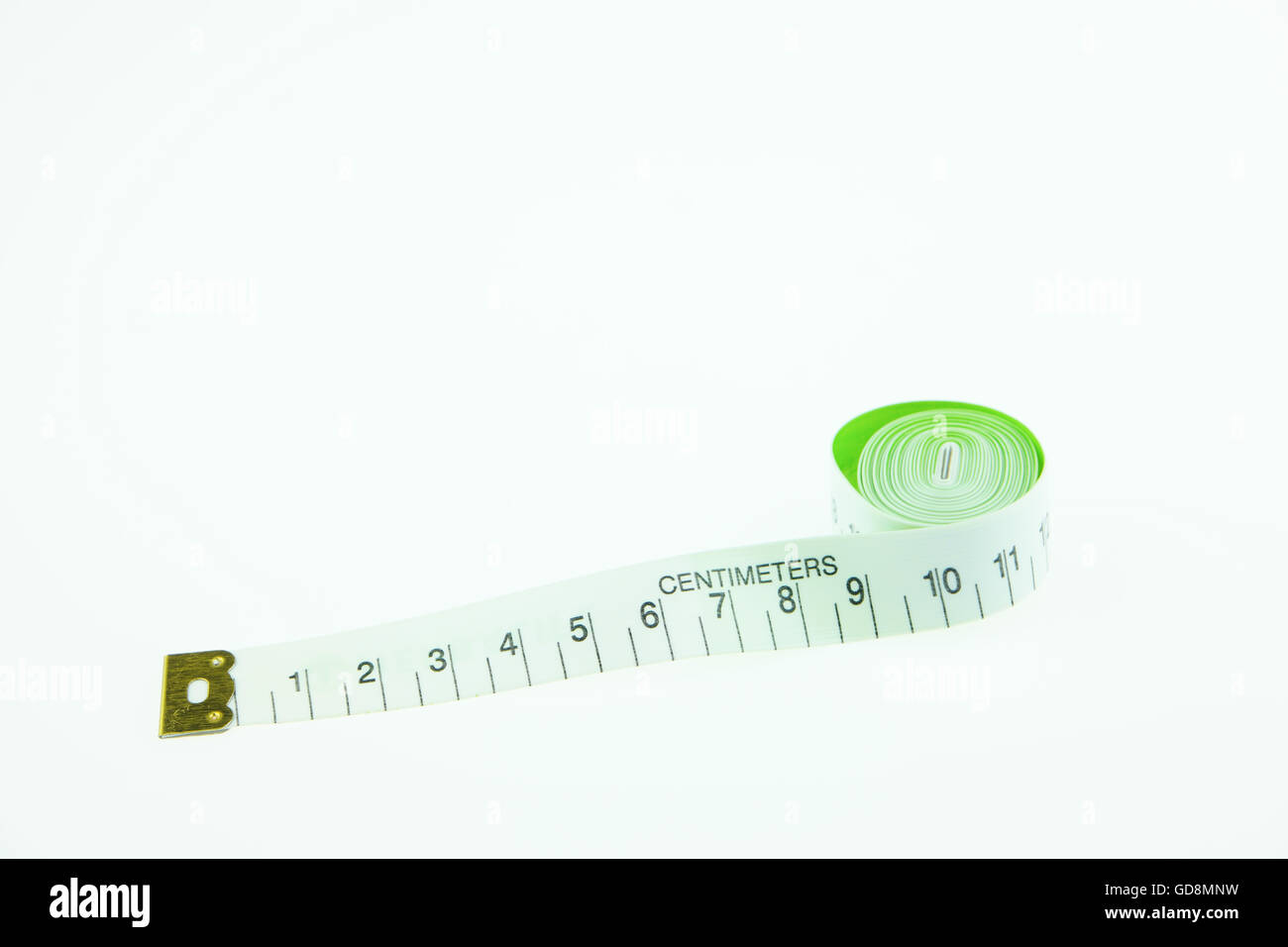 Measuring waist of sportswoman with tape measure stock photo