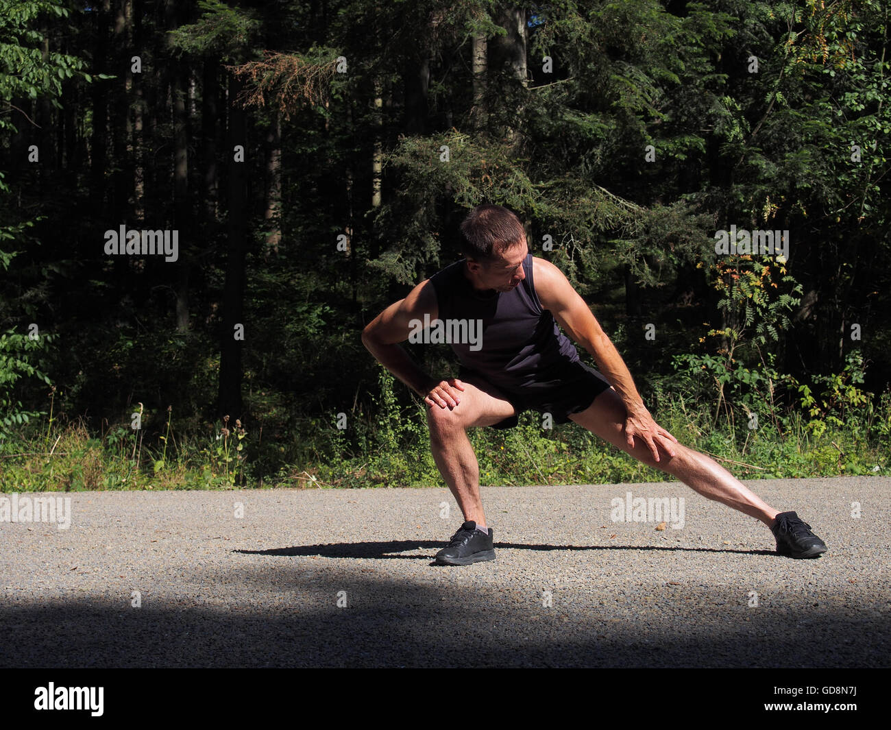 Man stretching side road hi-res stock photography and images - Alamy