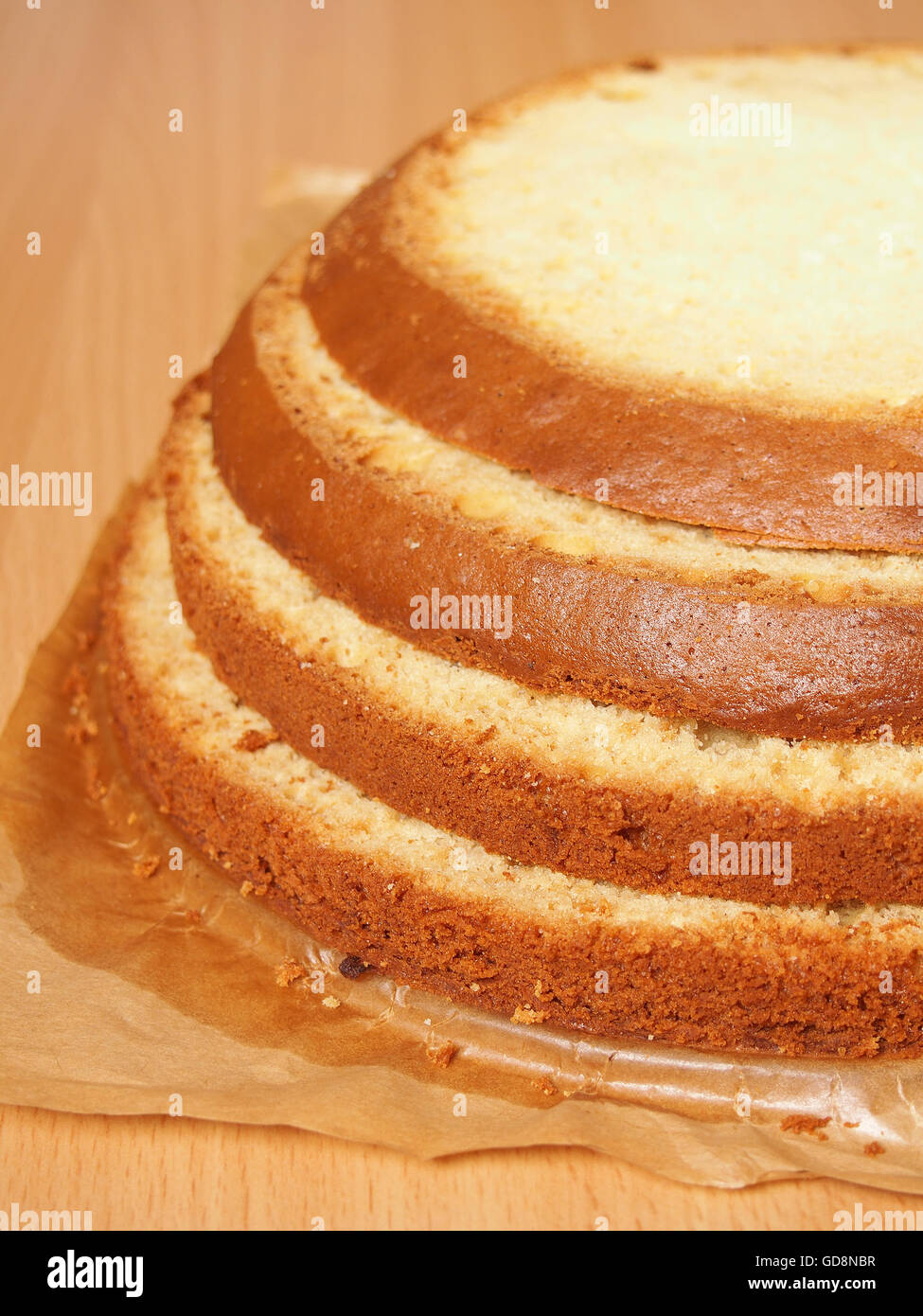 Cutting cake into layers. Making torte with buttercream filling and