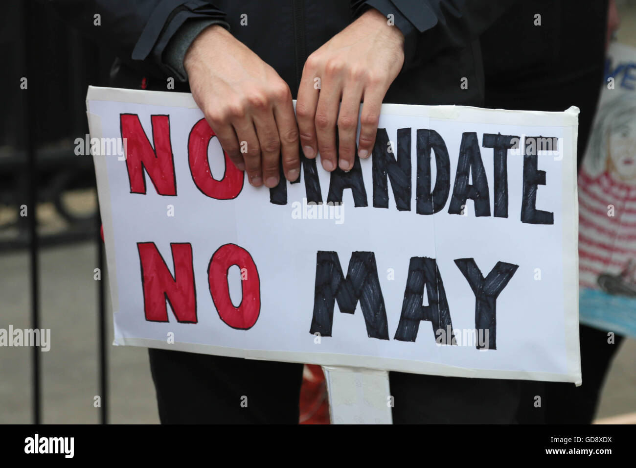 London UK. 13 July 2016 Demonstrators holding placards and Banners out side the gates of Downing street call on the new Prime Minster Theresa May to call a general election because they say she as no Mandate.. Credit:  Thabo Jaiyesimi/Alamy Live News Stock Photo