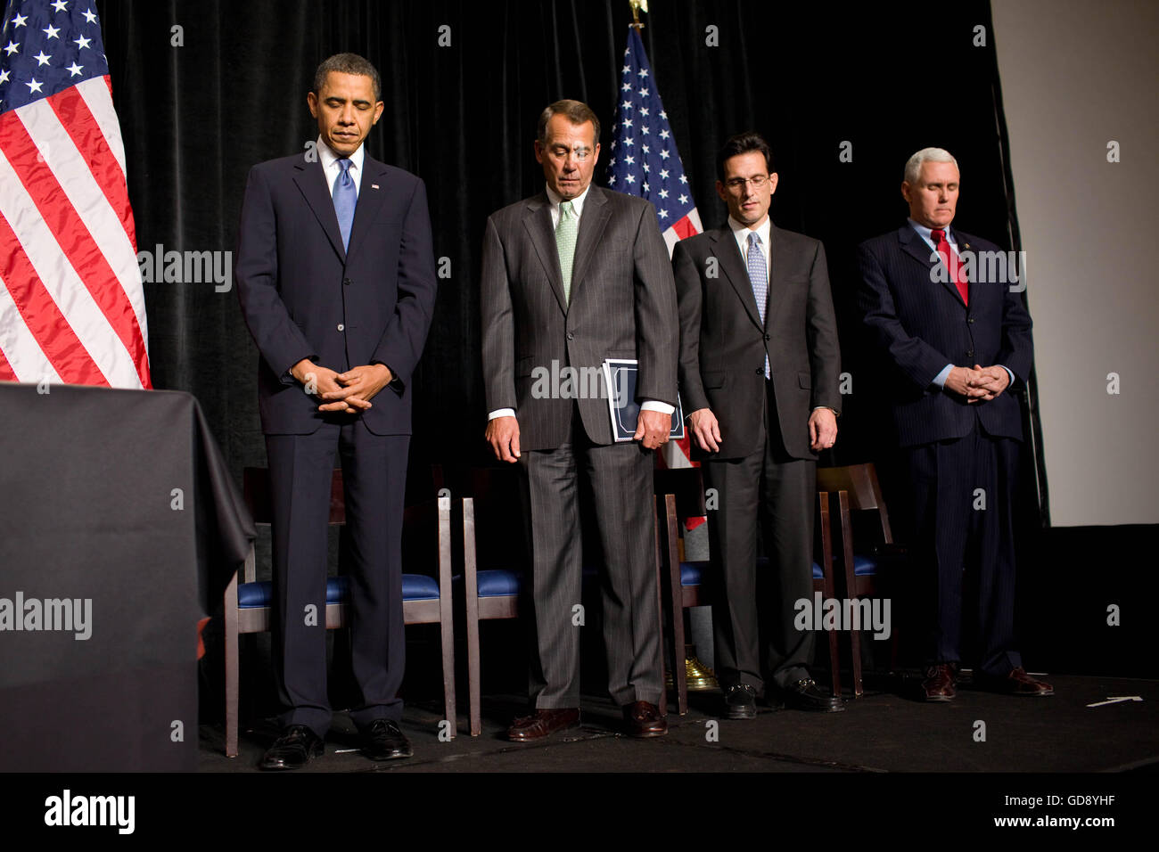 Baltimore, Maryland, USA. 29th Jan, 2010. United States President Barack Obama bows his head during the invocation at the nationally televised Republican House Issues Conference at the Renaissance Baltimore Harborplace Hotel in Baltimore, Maryland, January 29, 2010. With the President on-stage, from left, are US House Republican leader John Boehner (Republican of Ohio), US House Republican Whip Eric Cantor (Republican of Virginia) and Chair of the US House Republican Conference Mike Pence (Republican of Indiana). Mandatory Credit: Pete Souza/White House via CNP (Cre Stock Photo