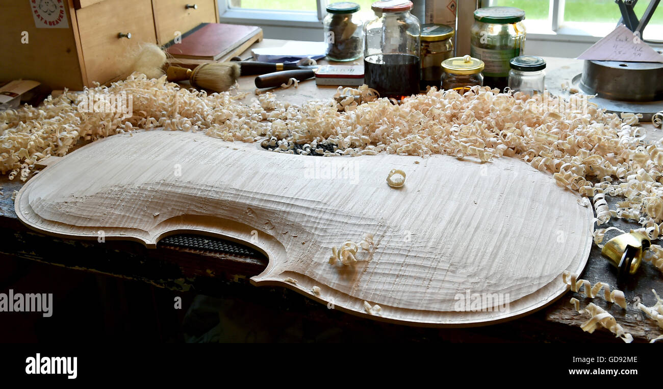 The back of a cello lies on a workbench in the workshop of instrument maker Ian Crawford McWilliams in Brandenburg on the Havel, Germany, 2 June 2016. The Canadian McWilliams builds handmade fiddles, violas, cellos and chelys that are sold worldwide. Photo: Bernd Settnik/ZB Stock Photo