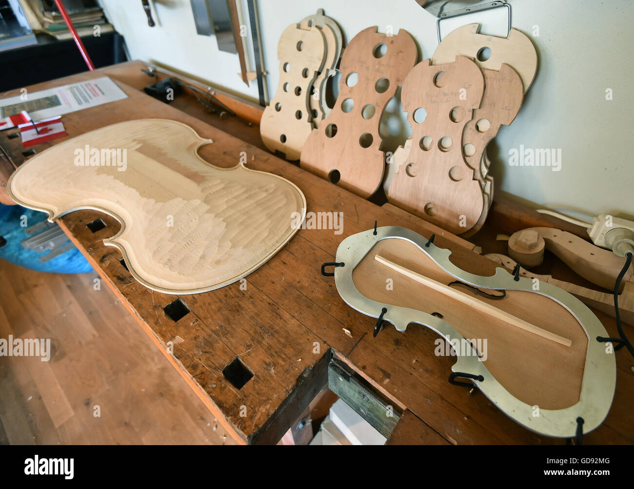 The back of a cello lies on a workbench in the workshop of instrument maker Ian Crawford McWilliams in Brandenburg on the Havel, Germany, 2 June 2016. The Canadian McWilliams builds handmade fiddles, violas, cellos and chelys that are sold worldwide. Photo: Bernd Settnik/ZB Stock Photo