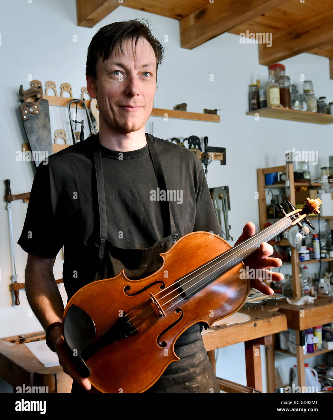Instrument maker Ian Crawford McWilliams holds a finished viola in his hands in his workshop in Brandenburg on the Havel, Germany, 2 June 2016. The Canadian McWilliams builds handmade fiddles, violas, cellos and chelys that are sold worldwide. Photo: Bernd Settnik/ZB Stock Photo