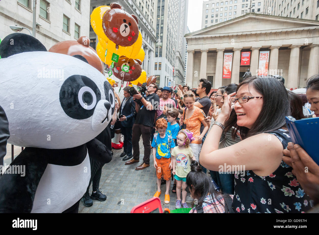 New York, USA. 14th July, 2016. Costumed characters representing Line 'stickers' in front of the New York Stock Exchange decorated for the Japanese messaging company Line's initial public offering on Thursday, July 14, 2016. Line Corp., a popular messaging app in Japan is owned by South Korean Naver Corp. Line has 218 million active users monthly, with Japan, Taiwan and Indonesia accounting for two-thirds of them.  Credit:  Richard Levine/Alamy Live News Stock Photo