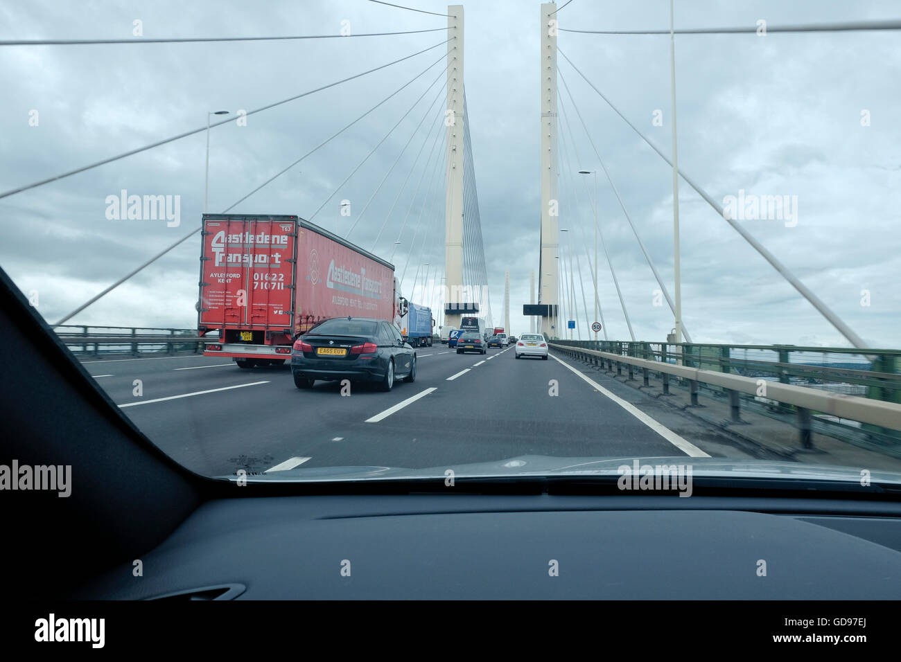 Heavy duty 18 wheeler truck and motor traffic on the Dartford Crossing bridge through a car windscreen Stock Photo
