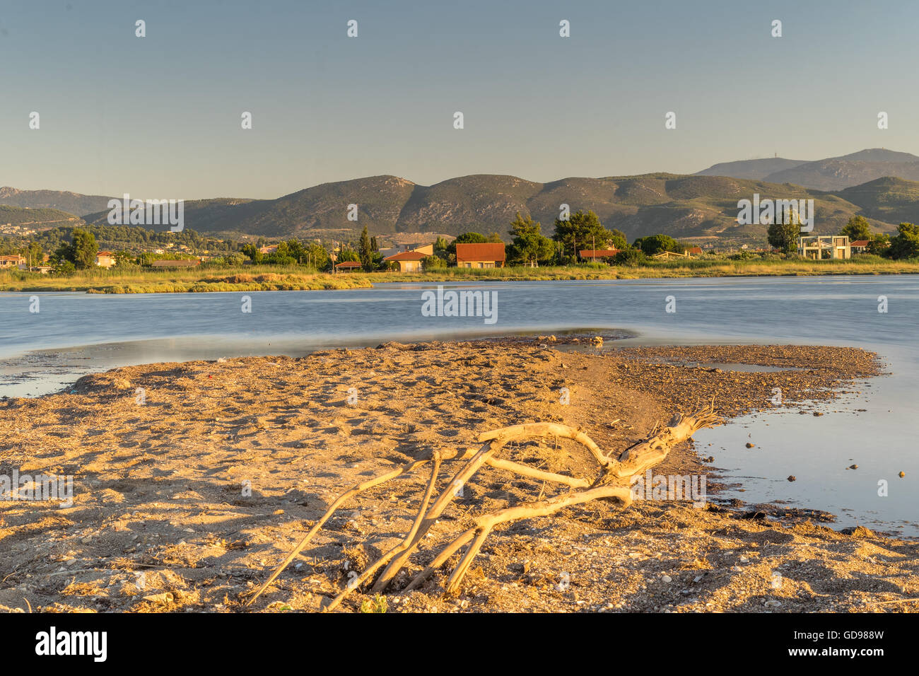 Beautiful scenery at the wetland of Oropos in Greece with traditional old and colorful houses against the lake. Stock Photo