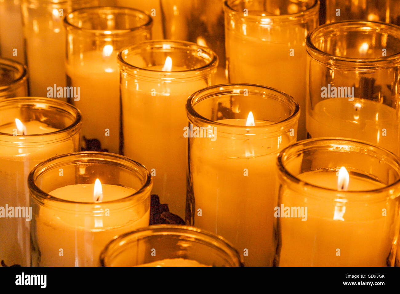 Rows of golden votive candles at St. Louis Cathedral in the French Quarter of New Orleans, Louisiana Stock Photo