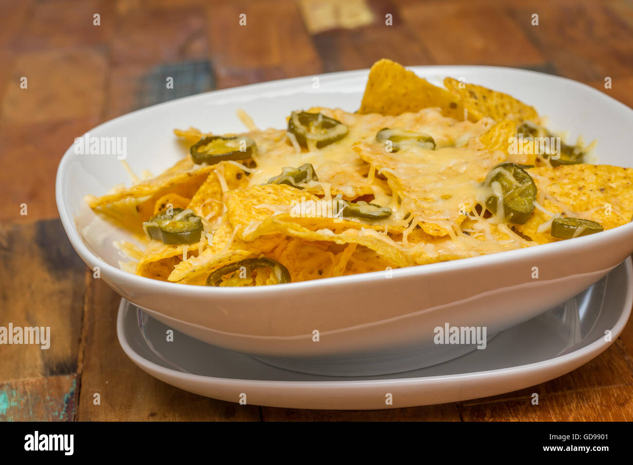 Nachos cheese with cheese and jalapenos in a white bowl Stock Photo