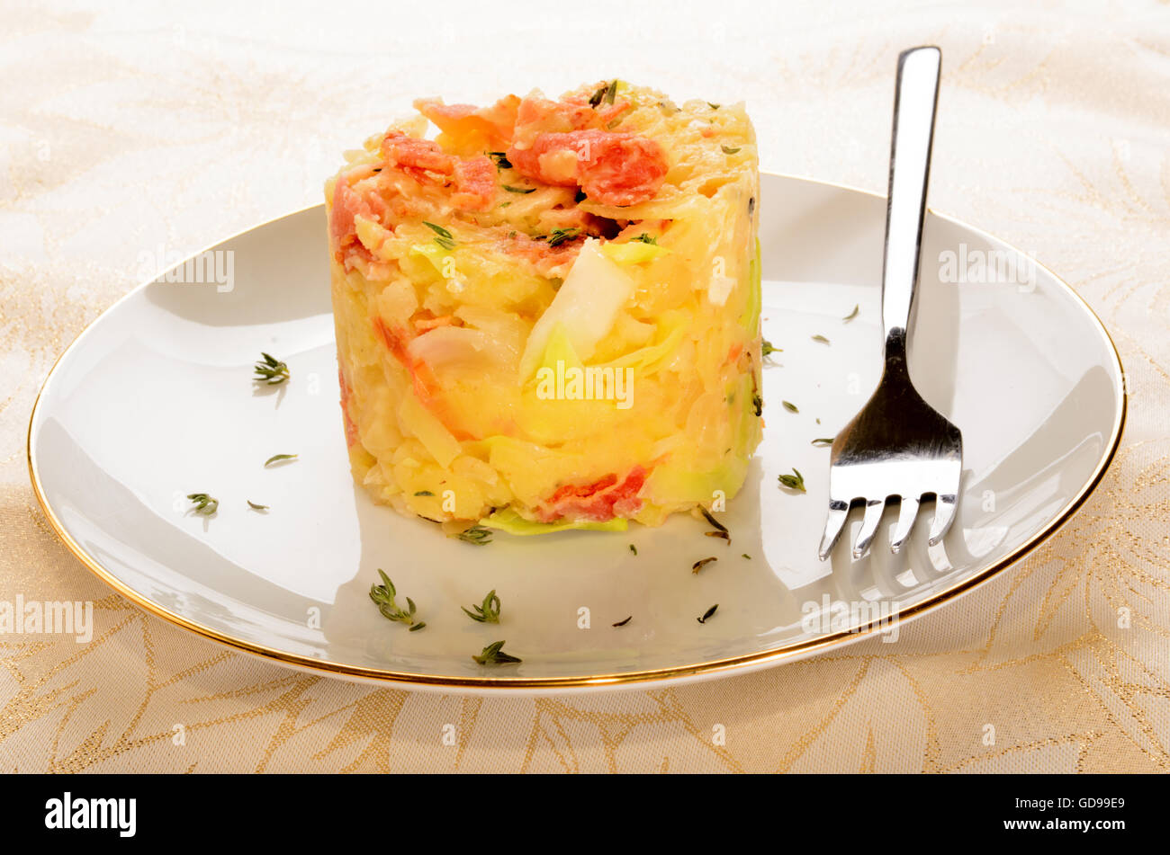 irish colcannon, made with mashed potato, cabbage, grilled bacon and crushed peppercorn served on a plate Stock Photo
