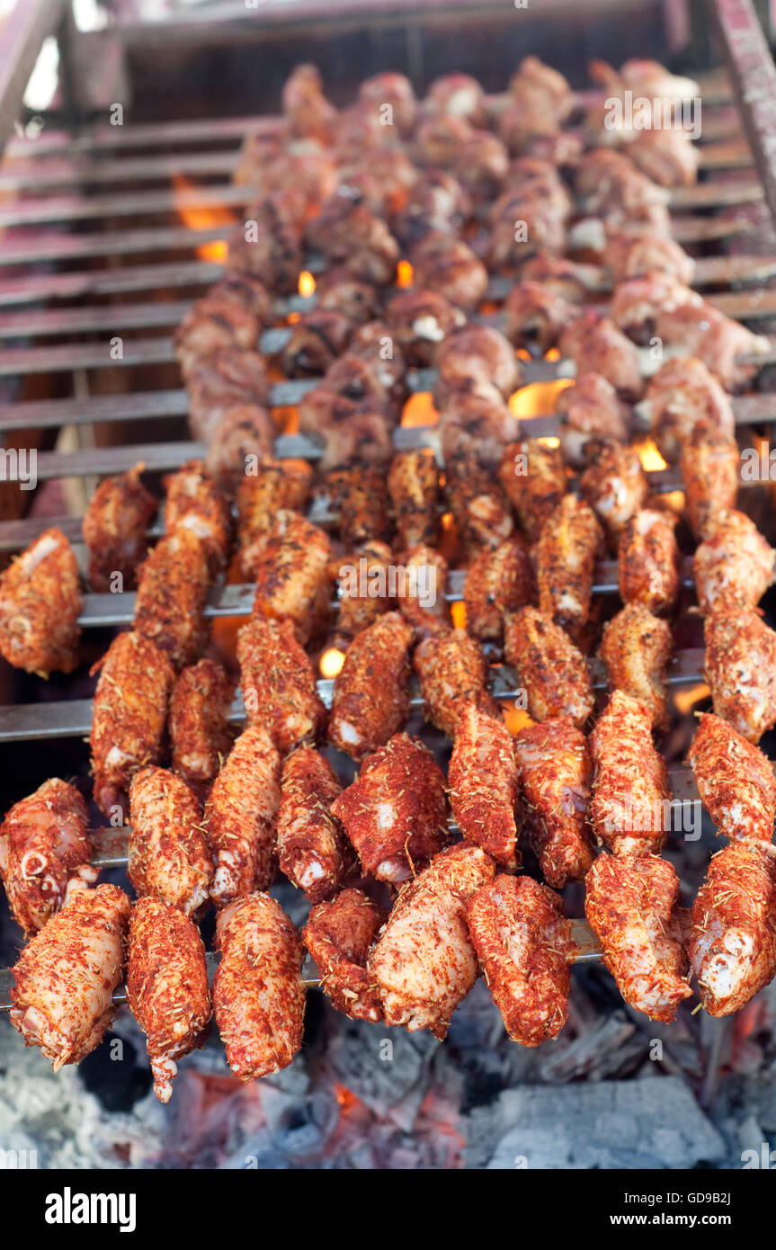 Italy, Lombardy, Street Food, Spicy Chicken Wings on the Grill Stock Photo
