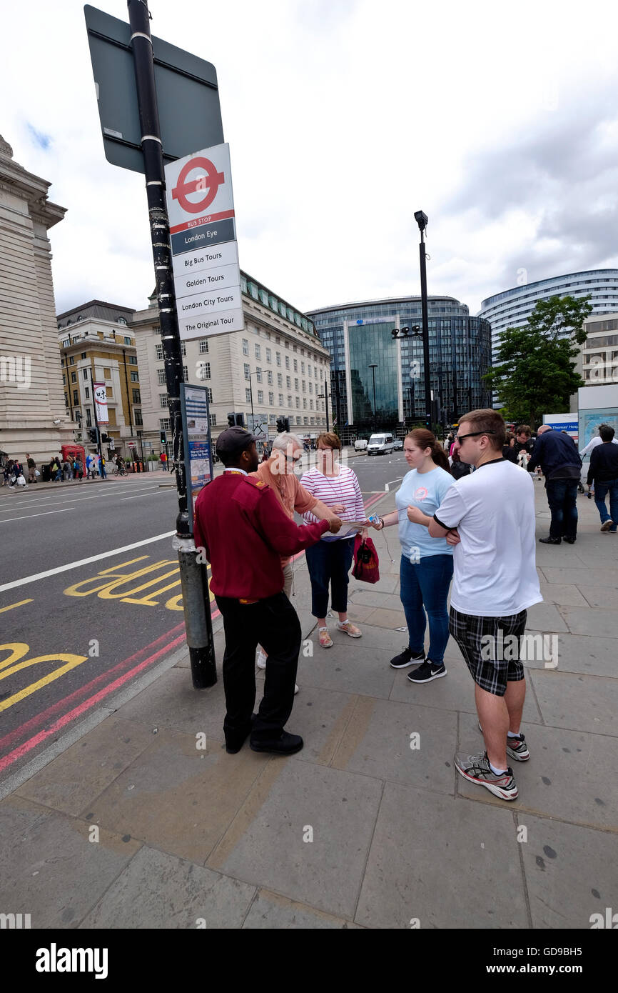 A Big Bus customer service person assists tourists with information in